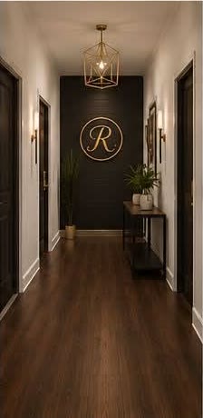 Salon suite hallway with Renaissance logo wall and warm pendant lighting